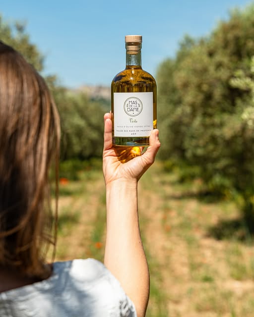 Photo by Mas De La Dame on June 22, 2026. May be an image of bottle, olive oil, wine bottle and text.